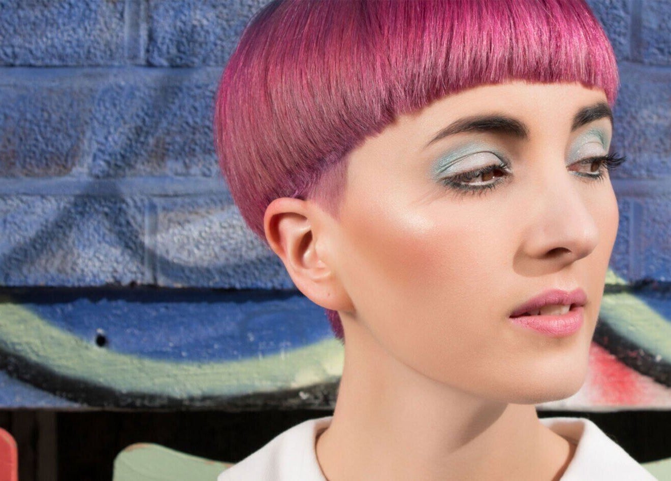 Close-up of woman with vibrant pink hair at Paint London, London, England, GB, showing bold style and artistry.