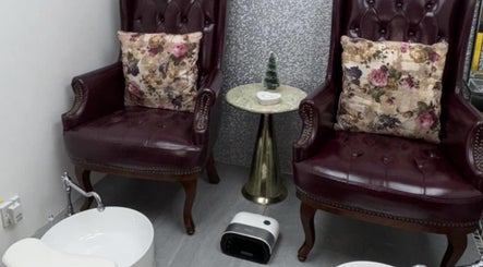 Luxurious seating at Leila’s Beauty Lounge, Birmingham, England, GB, featuring plush chairs and a pedicure station.