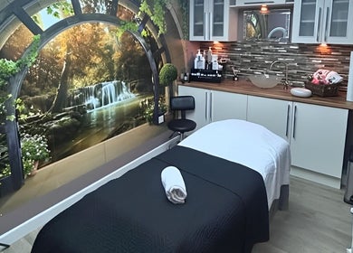 Relaxation room at Leila’s Beauty Lounge, Birmingham, England, GB showcasing a serene waterfall mural.