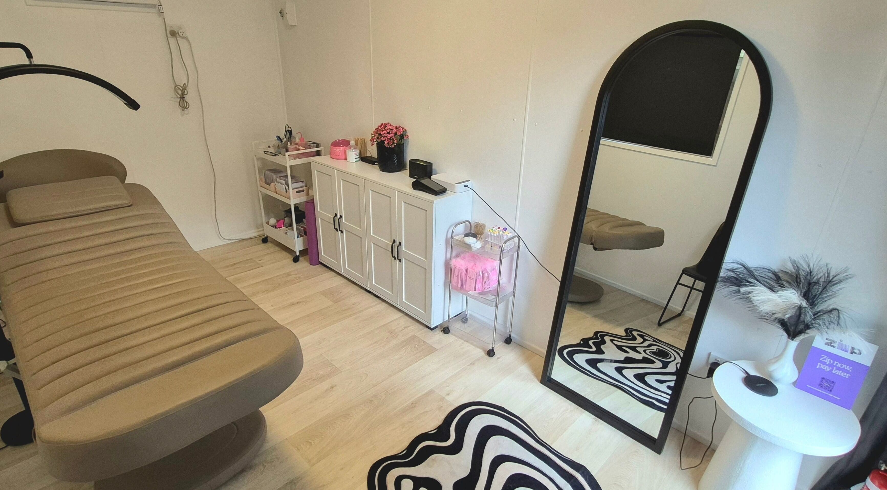 Tranquil treatment room at Lottie's Place - Loganlea, Queensland, AU with cozy decor and elegant furnishings.