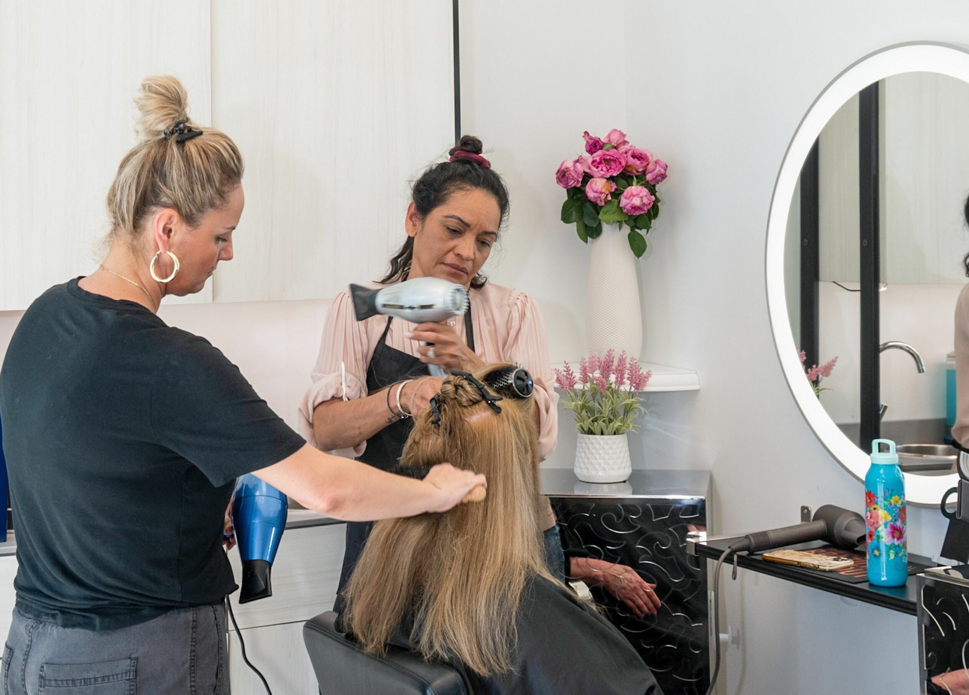 Stylists at Jennifer The Hairstylist in Delray Beach tending to a customer's hair in Delray Beach, Florida, US.