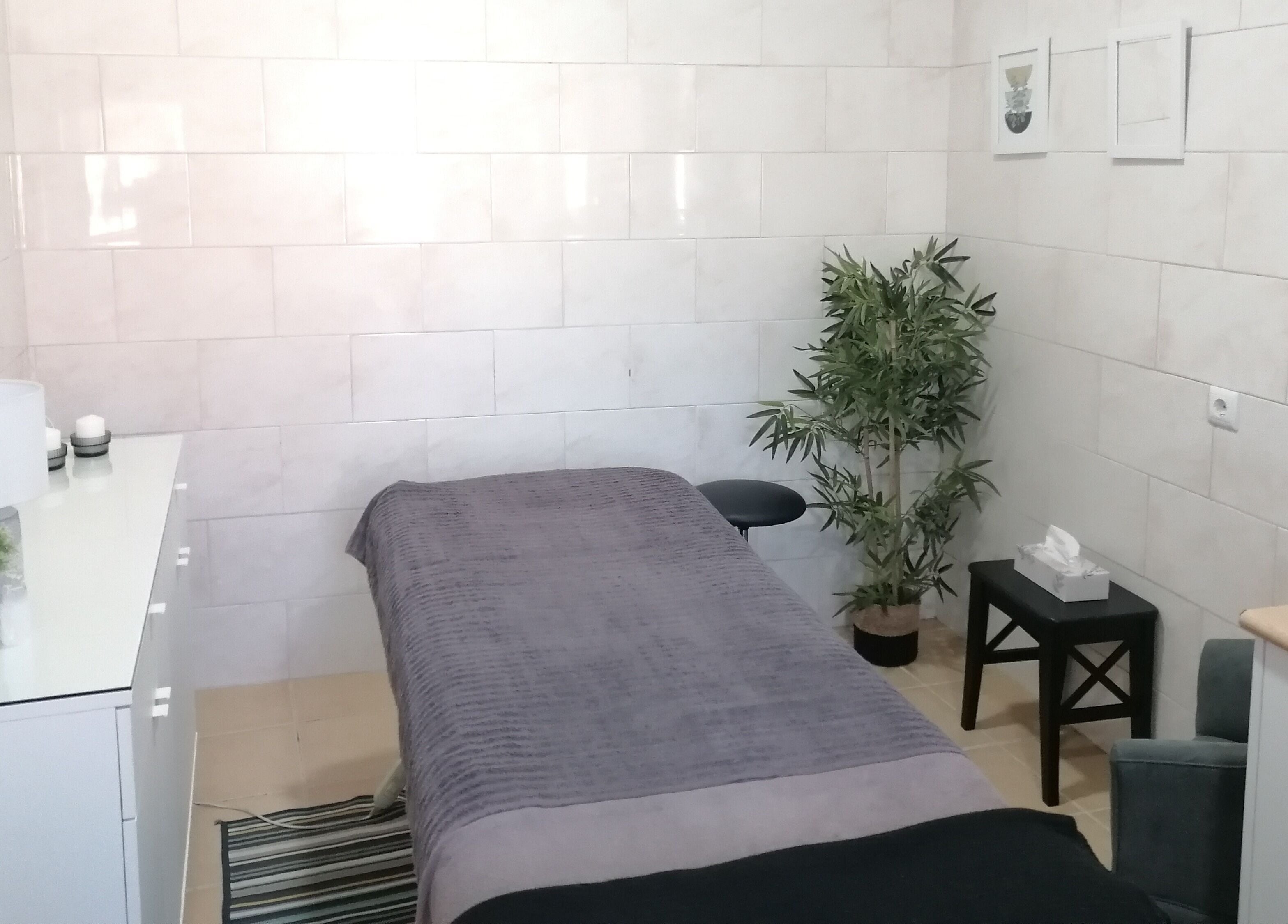 Sala de massagem em Terapeuta Cátia Sousa, Gondomar, Porto, PT, com mesa, plantas e decoração acolhedora.