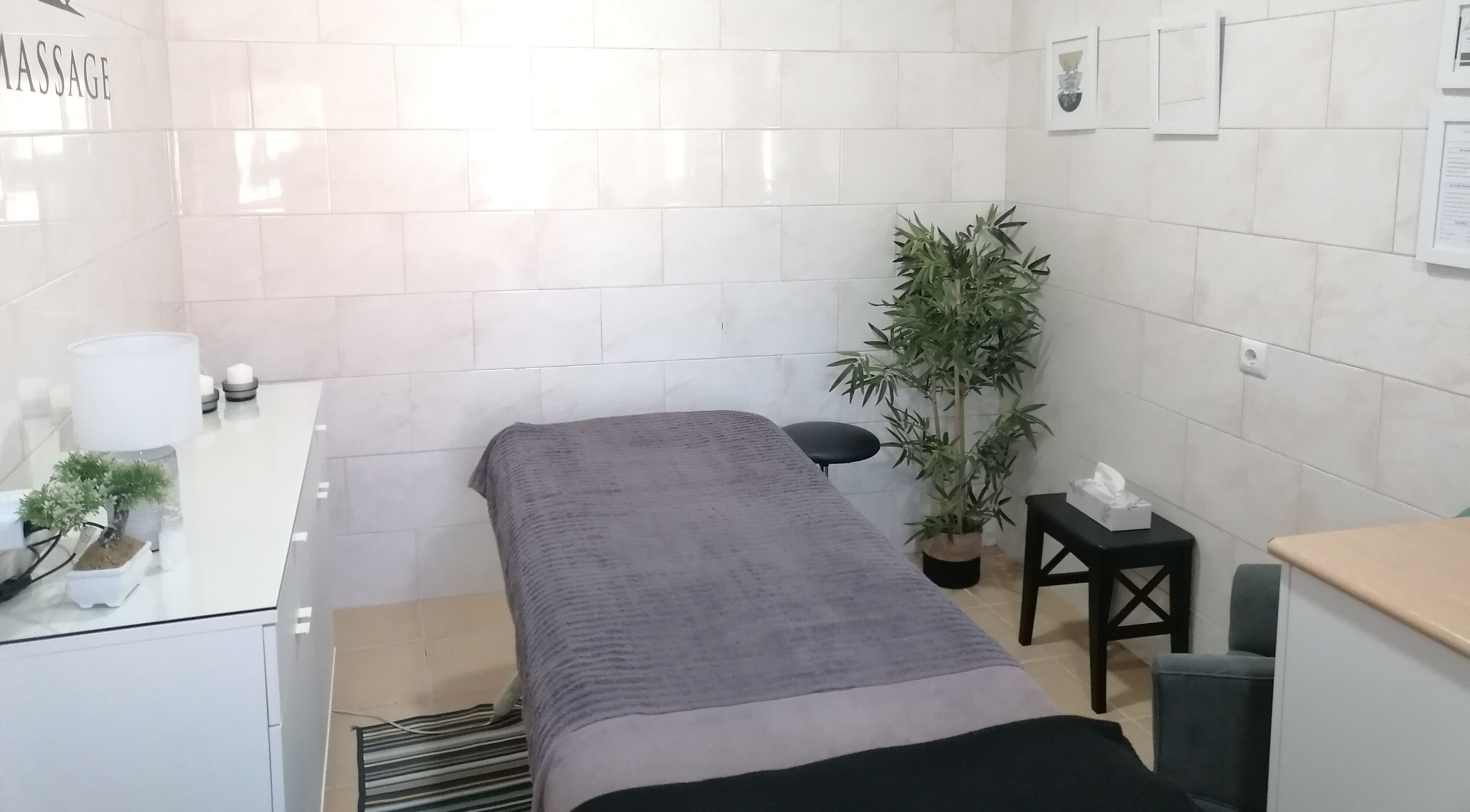 Sala de massagem em Terapeuta Cátia Sousa, Gondomar, Porto, PT, com mesa, plantas e decoração acolhedora.
