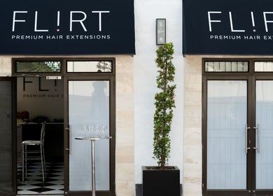 Entrance of Flirt Hair and Beauty Bar, Pretoria, Gauteng, ZA, featuring stylish doors and signage.