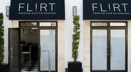 Entrance of Flirt Hair and Beauty Bar, Pretoria, Gauteng, ZA, featuring stylish doors and signage.