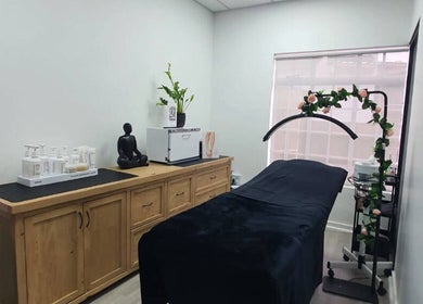Calming treatment room at Flirt Hair and Beauty Bar, Pretoria, Gauteng, ZA with massage bed and decor.