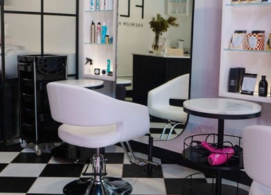 Interior of Flirt Hair and Beauty Bar in Pretoria, Gauteng, ZA, showcasing chic salon chairs and hair products.