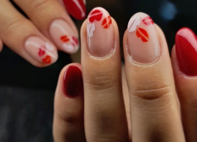 Stylish red manicure with artistic design at Flirt Hair and Beauty Bar, Pretoria, Gauteng, ZA.