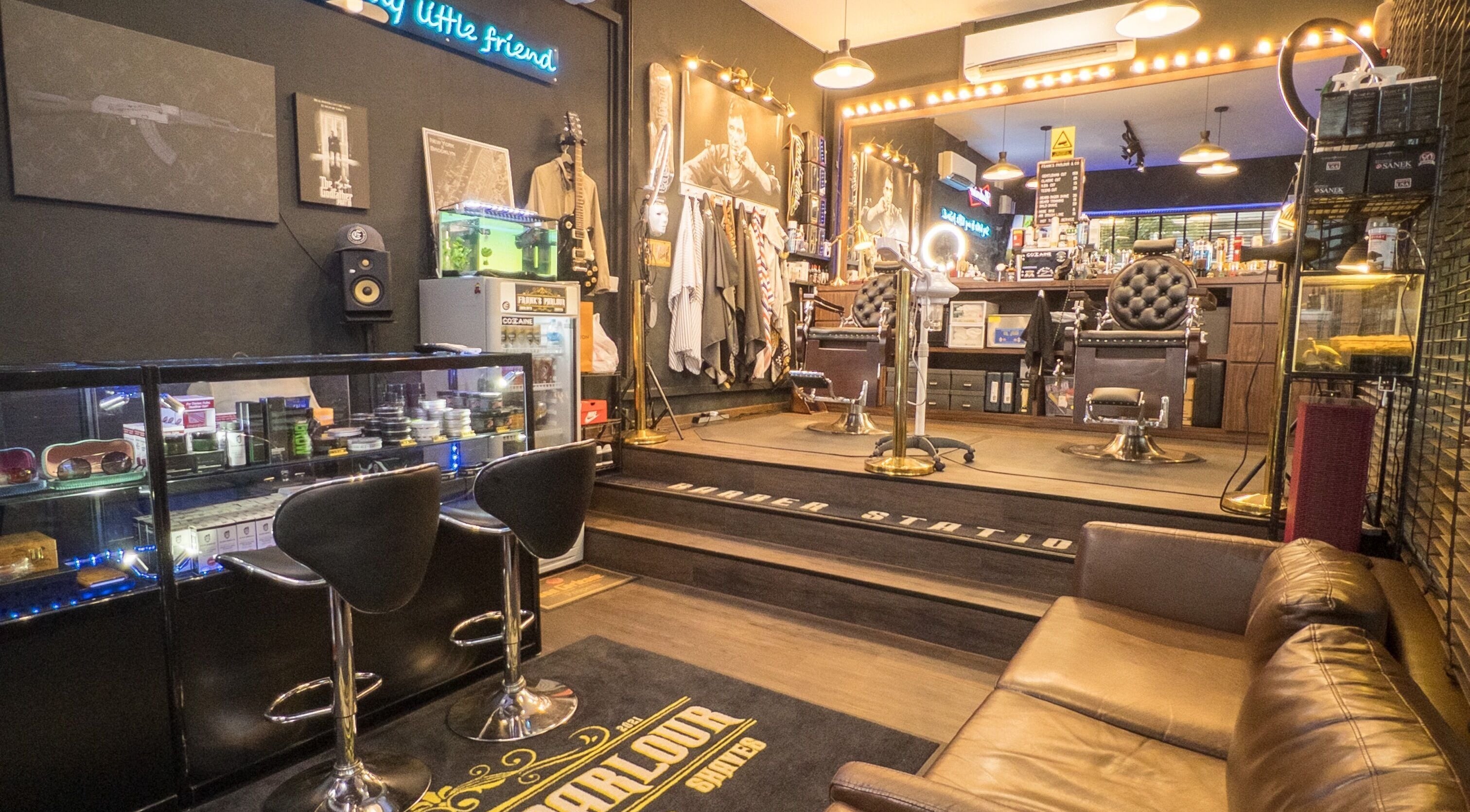Frank's Parlour & Co in Singapore offers a stylish barber experience with modern decor and plush seating.