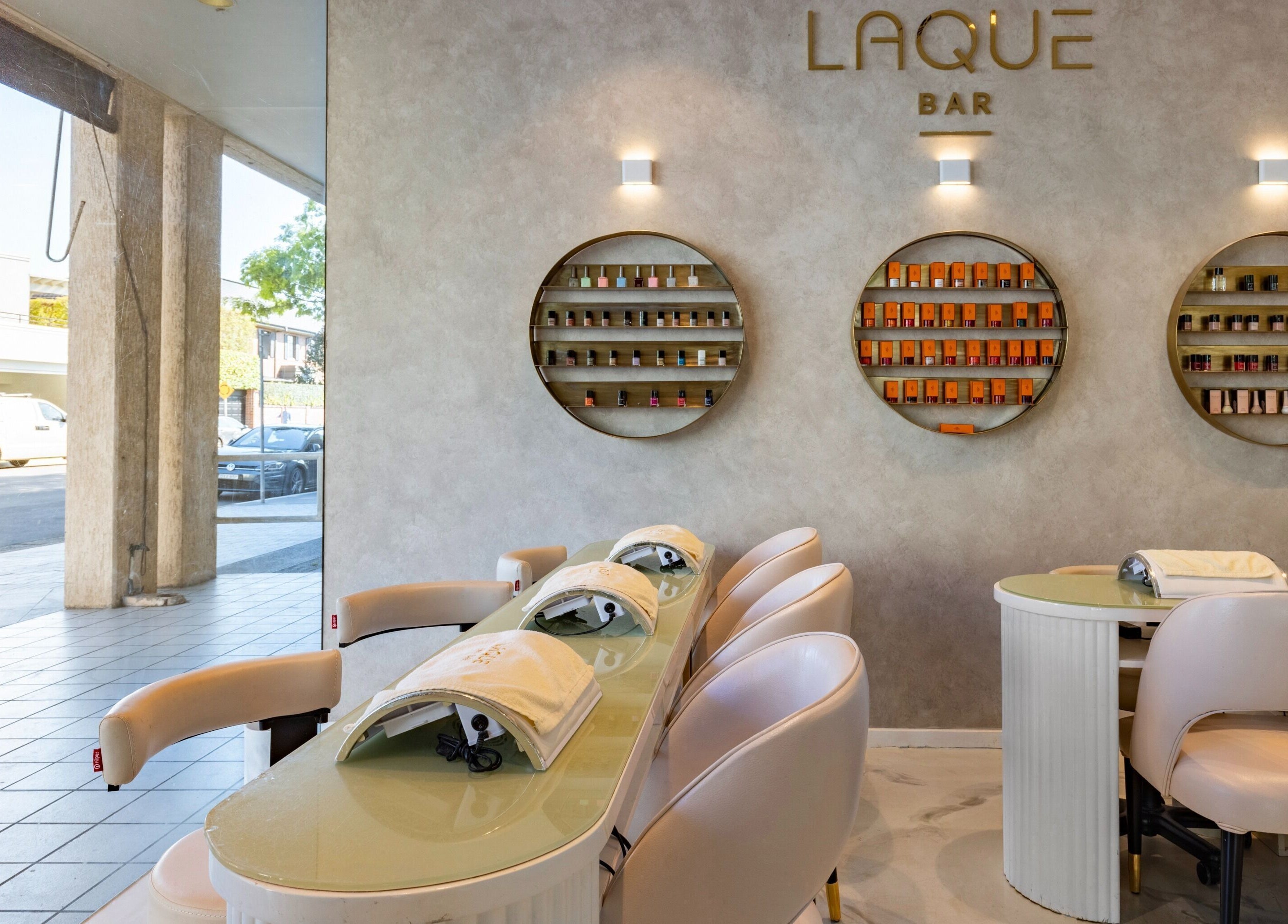 Chic interior of Laque Nail Bar - Double Bay, NSW, AU, showcasing elegant nail care stations and vibrant displays.
