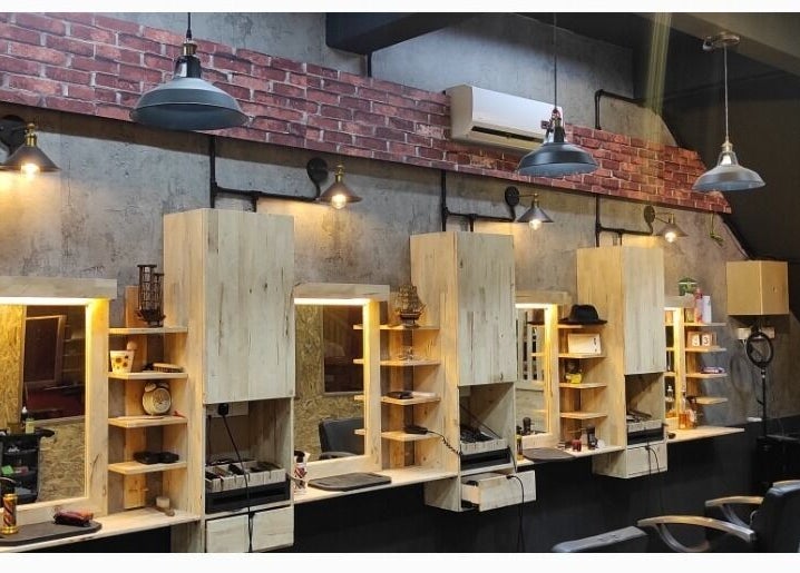 Modern interior of Barbossa Barbershop & Hairstylist in Kulim, Kedah, MY featuring stylish wooden workstations.