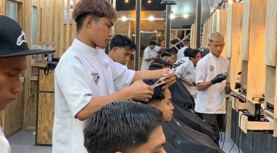 Barbers providing services at Barbossa Barbershop & Hairstylist in Kulim, Kedah, MY. Modern interior design.