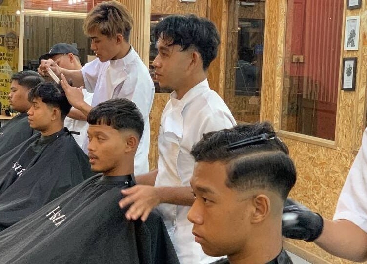 Skilled barbers at work in Barbossa Barbershop & Hairstylist, Kulim, Kedah, MY, providing expert grooming services.