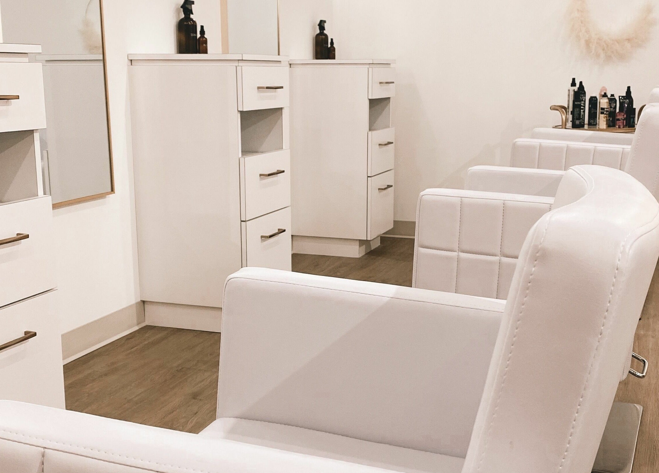 Elegant styling area at Hair Connection Cambridge in Cambridge, Ontario, CA, showcasing modern white chairs.