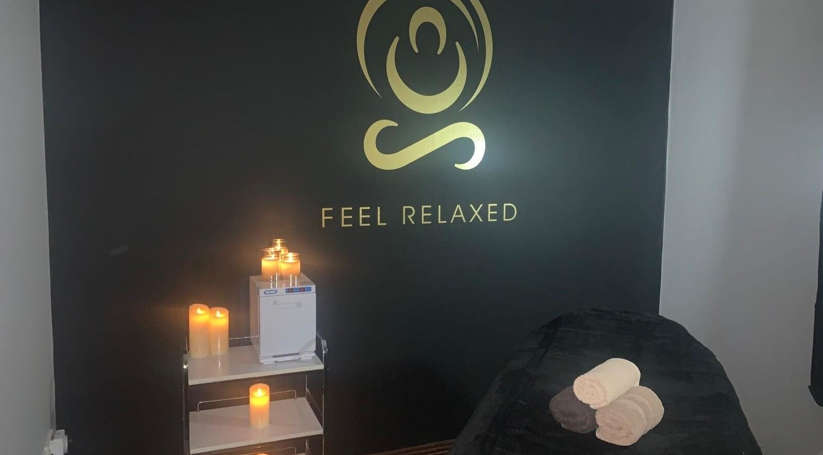 Cozy massage room at Aisha Kelly Beauty, Ennis, County Clare, IE, with candles and relaxing ambiance.