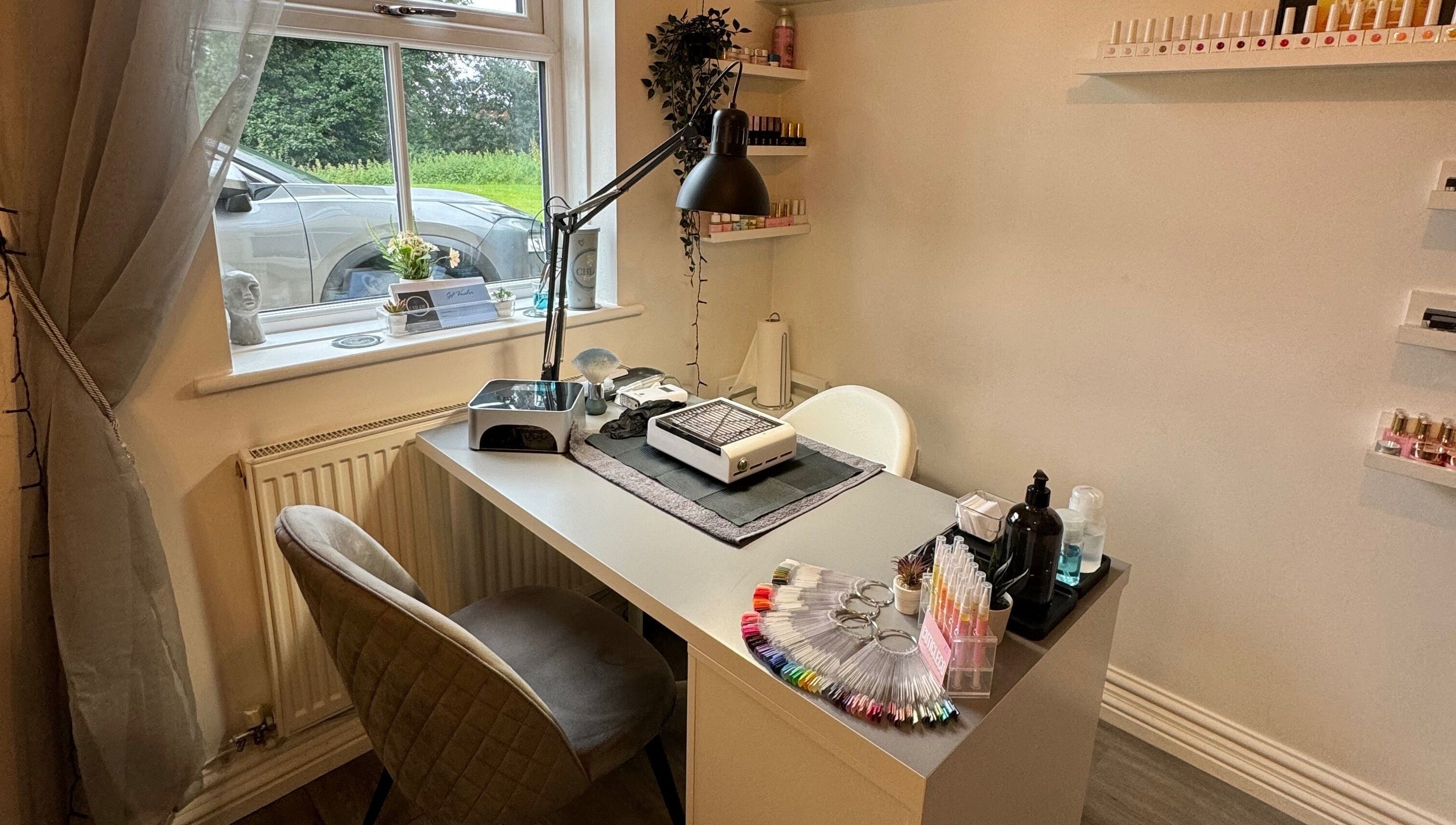 Chloe Elizabeth - Nails and Beauty's sleek nail station in Helsby, England, GB, with tools and nail polish display.
