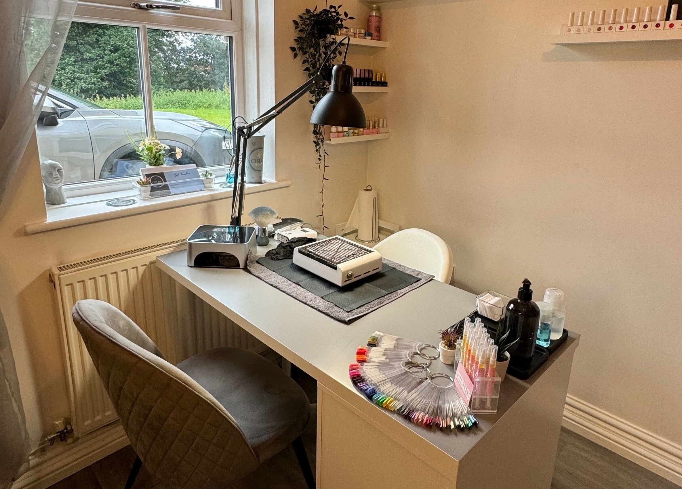 Chloe Elizabeth - Nails and Beauty's sleek nail station in Helsby, England, GB, with tools and nail polish display.