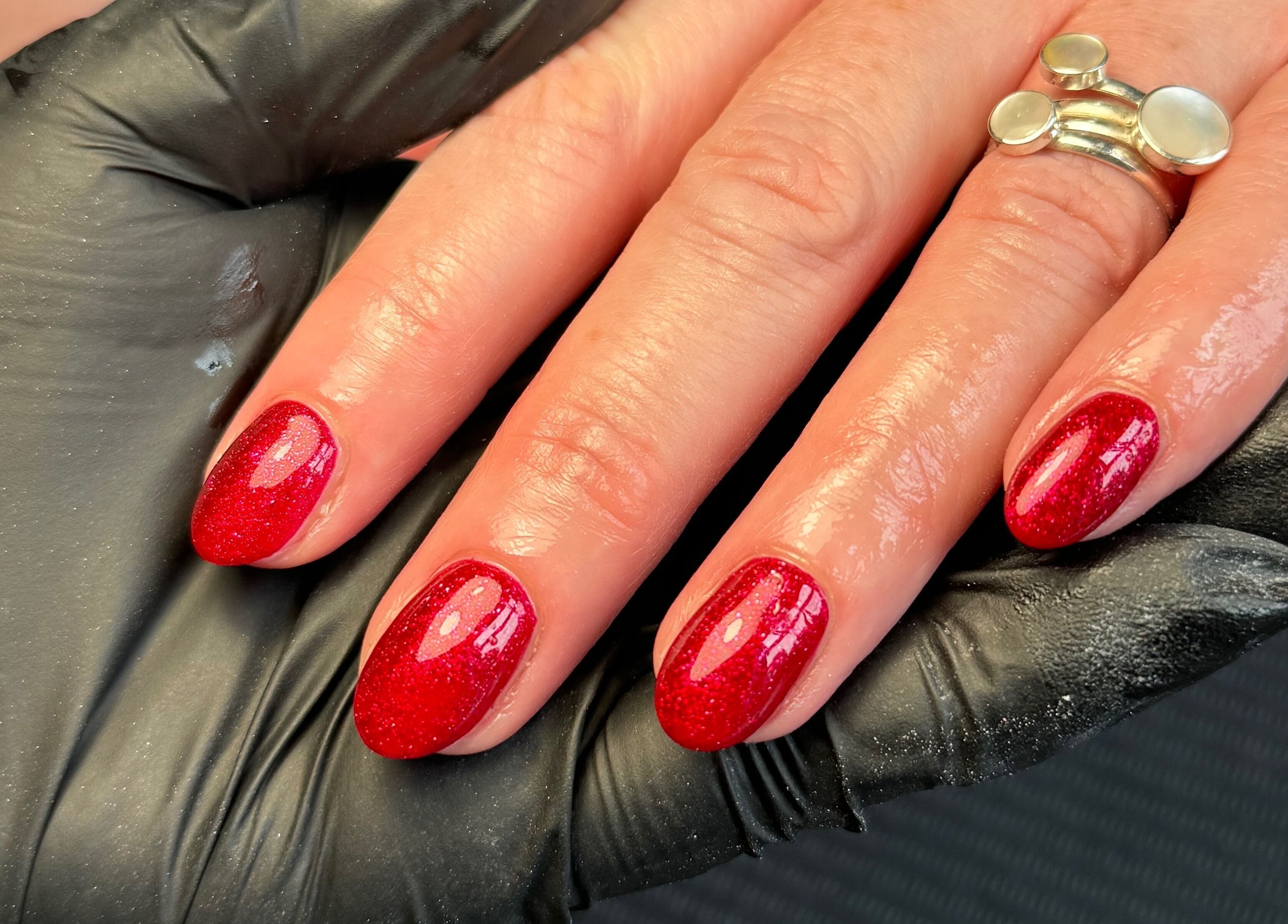 Chloe Elizabeth - Nails and Beauty in Helsby, England, showcases glittery red nails perfectly manicured.