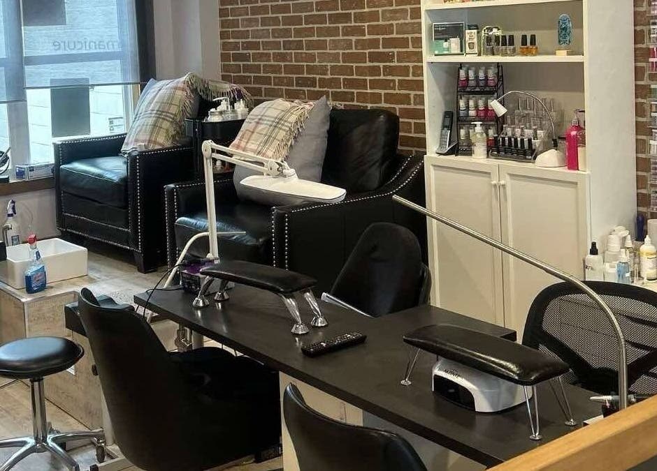 Cozy manicure area at Parlur Cosmetology Salon & Spa in Winnipeg, Manitoba, CA with plush seating and nail care setup.