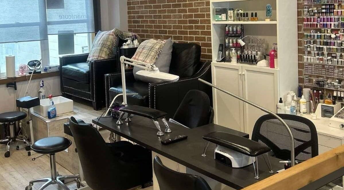Cozy manicure area at Parlur Cosmetology Salon & Spa in Winnipeg, Manitoba, CA with plush seating and nail care setup.