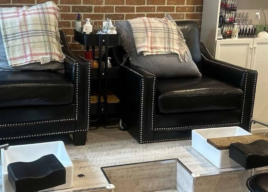 Comfortable pedicure setup at Parlur Cosmetology Salon & Spa in Winnipeg, Manitoba, CA with elegant black chairs.