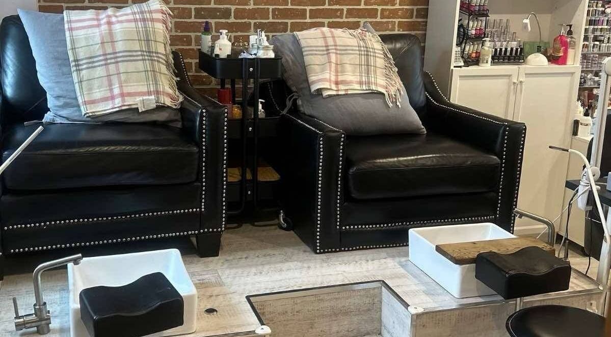 Comfortable pedicure setup at Parlur Cosmetology Salon & Spa in Winnipeg, Manitoba, CA with elegant black chairs.