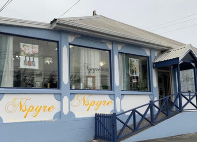 Nspyre Beauty exterior in Bridgetown, Christ Church, BB showcasing inviting blue and white facade with large windows.