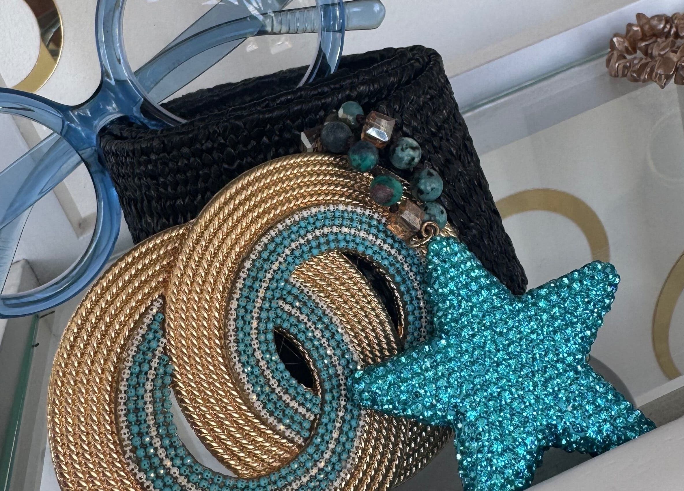 Stylish accessories at Nspyre Beauty, Bridgetown, Christ Church, BB. Blue glasses and elegant jewelry showcased.