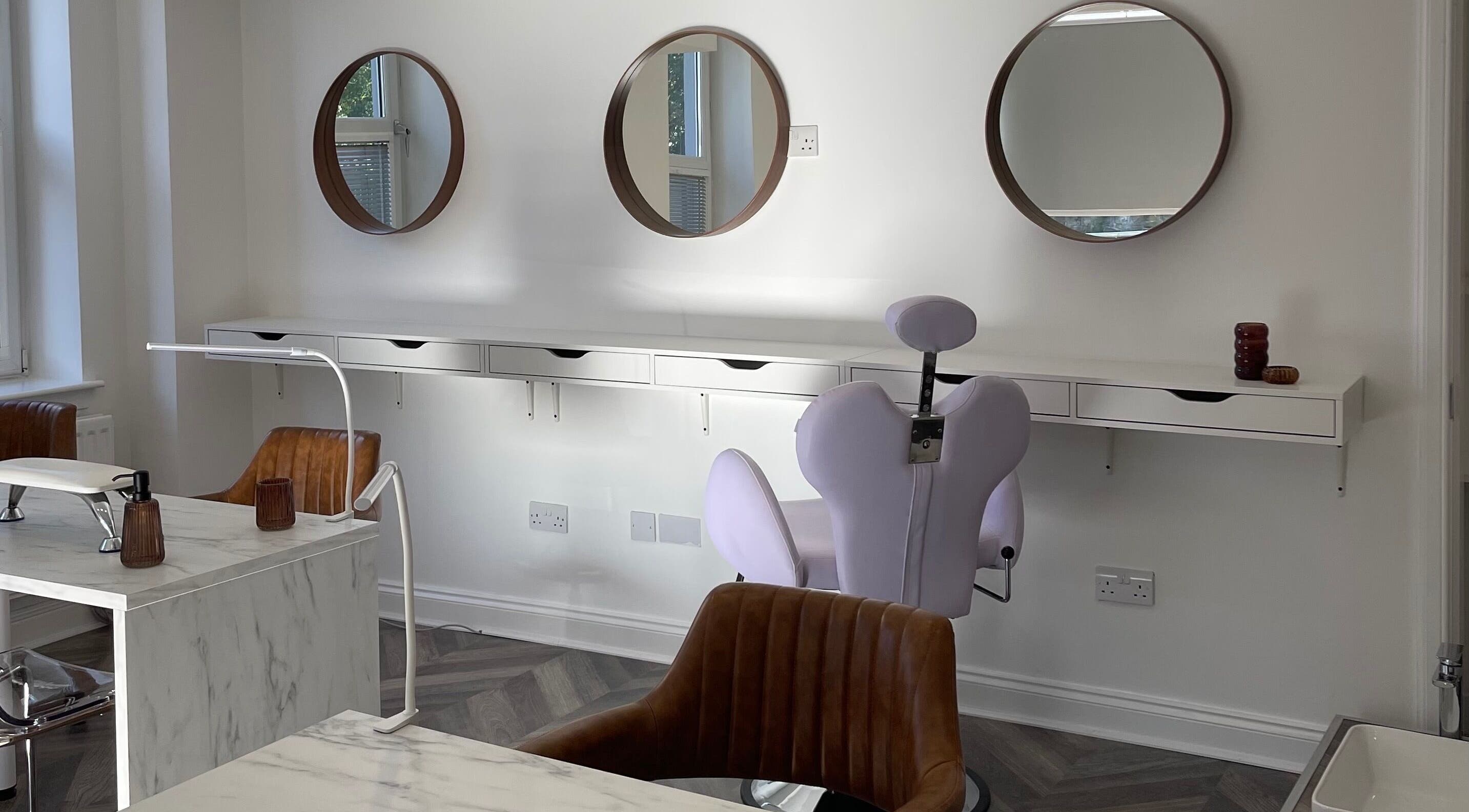 Modern salon interior with mirrors and chairs at Spice and Paint Salon, Bathgate, Scotland, GB.
