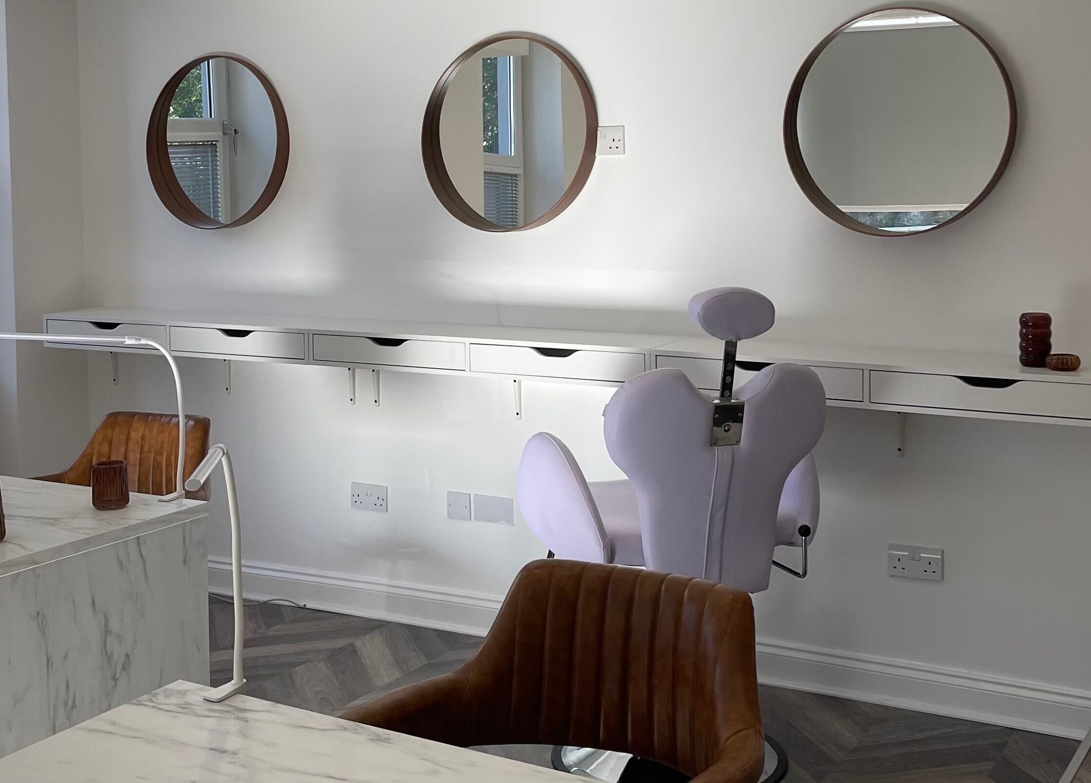 Modern salon interior at Spice and Paint Salon in Bathgate, Scotland, GB, featuring stylish mirrors and seating.