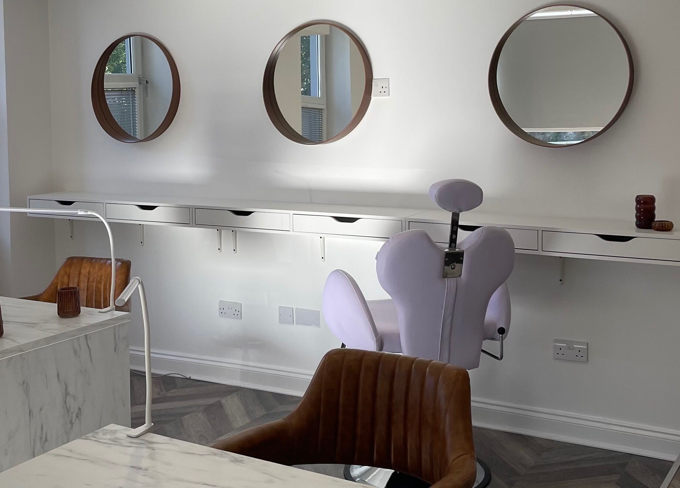 Modern salon interior at Spice and Paint Salon in Bathgate, Scotland, GB, featuring stylish mirrors and seating.