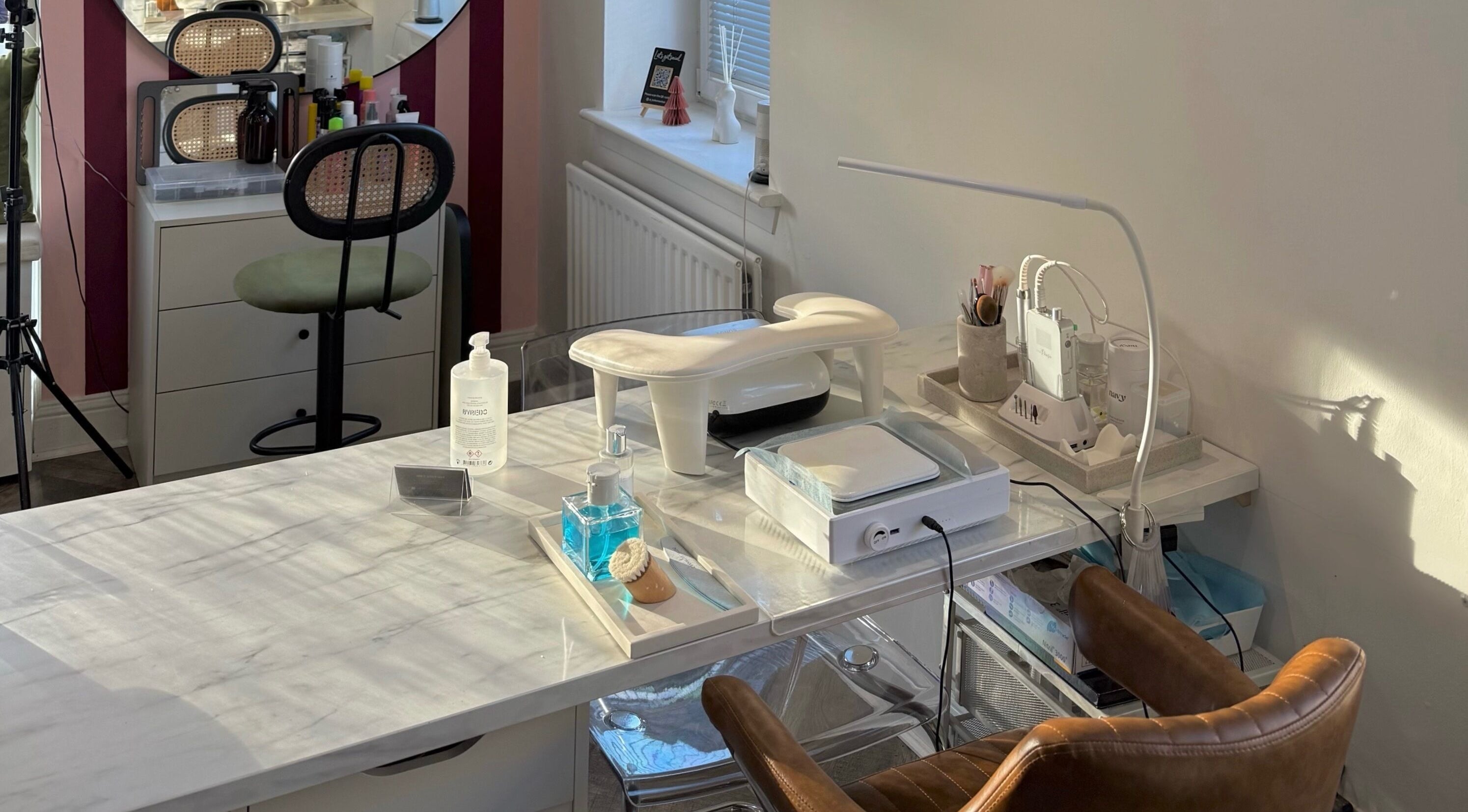 Nail station at Spice and Paint Salon, Bathgate, Scotland, GB featuring modern tools and cozy seating.