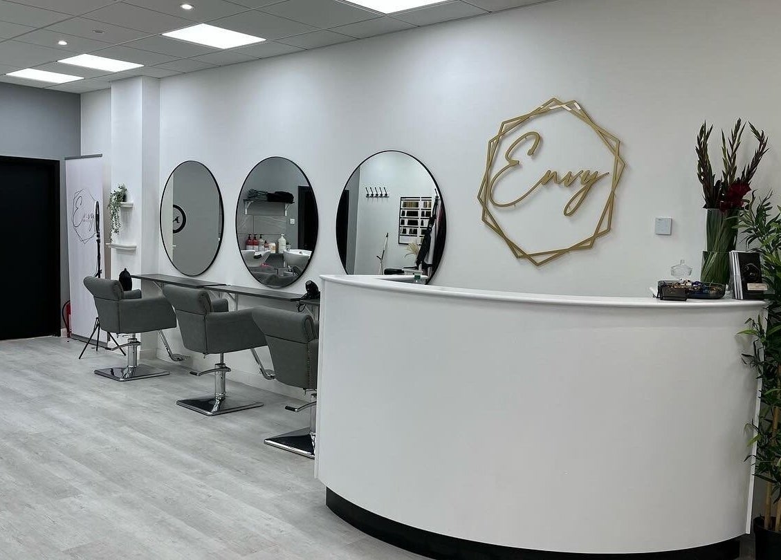 Modern interior of Envy Hair & Extensions in Eastbourne, England, GB featuring sleek styling stations and chic decor.