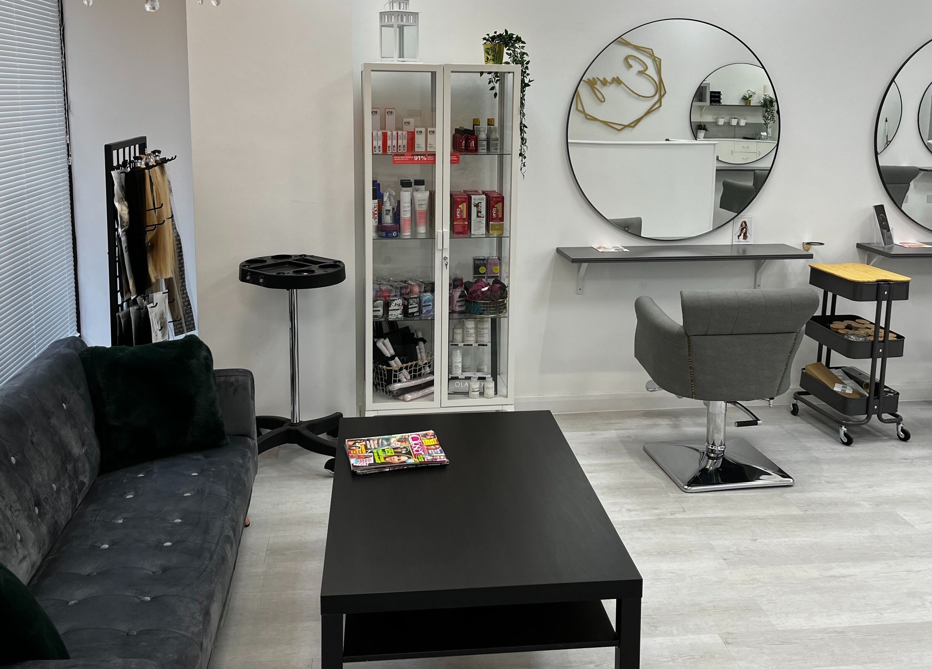 Sleek seating and styling area at Envy Hair & Extensions, Eastbourne, England, GB, showcasing modern elegance.