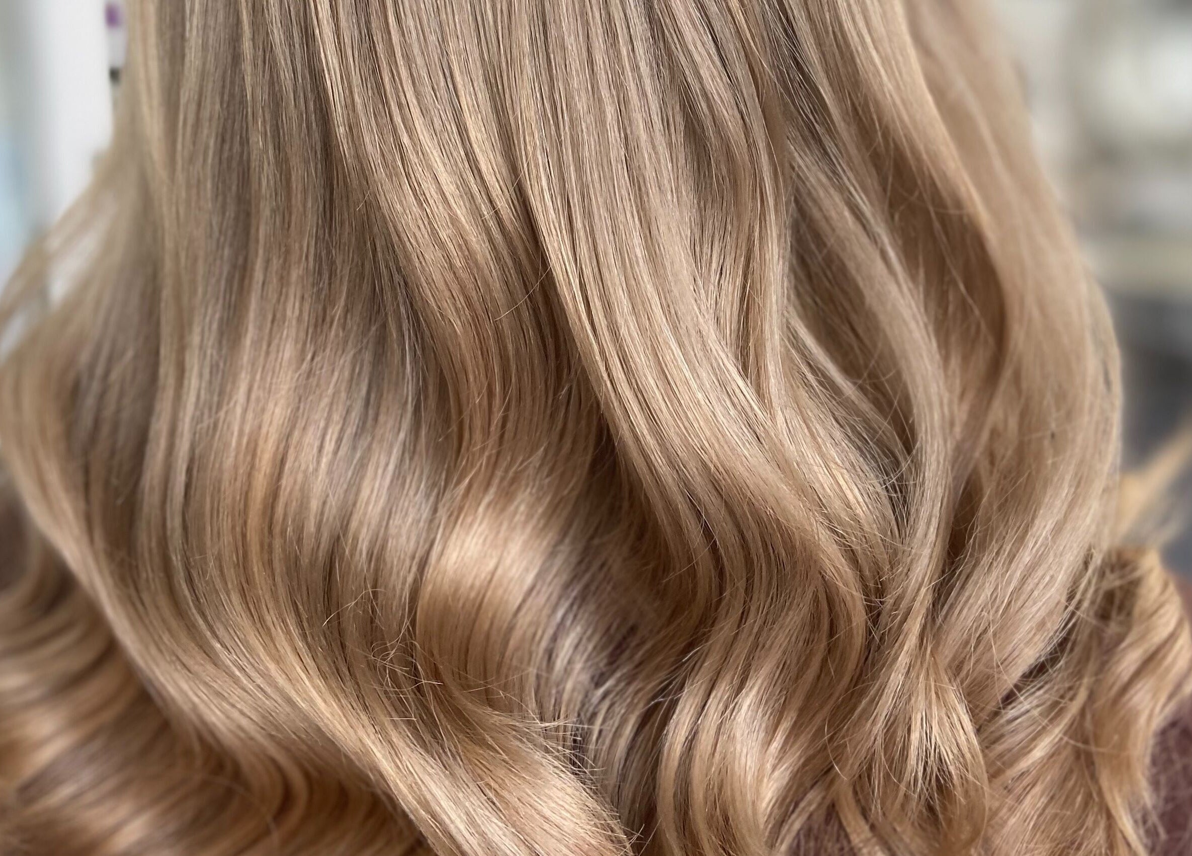 Elegant blonde waves styled at Envy Hair & Extensions, Eastbourne, England, GB, showcasing salon expertise.