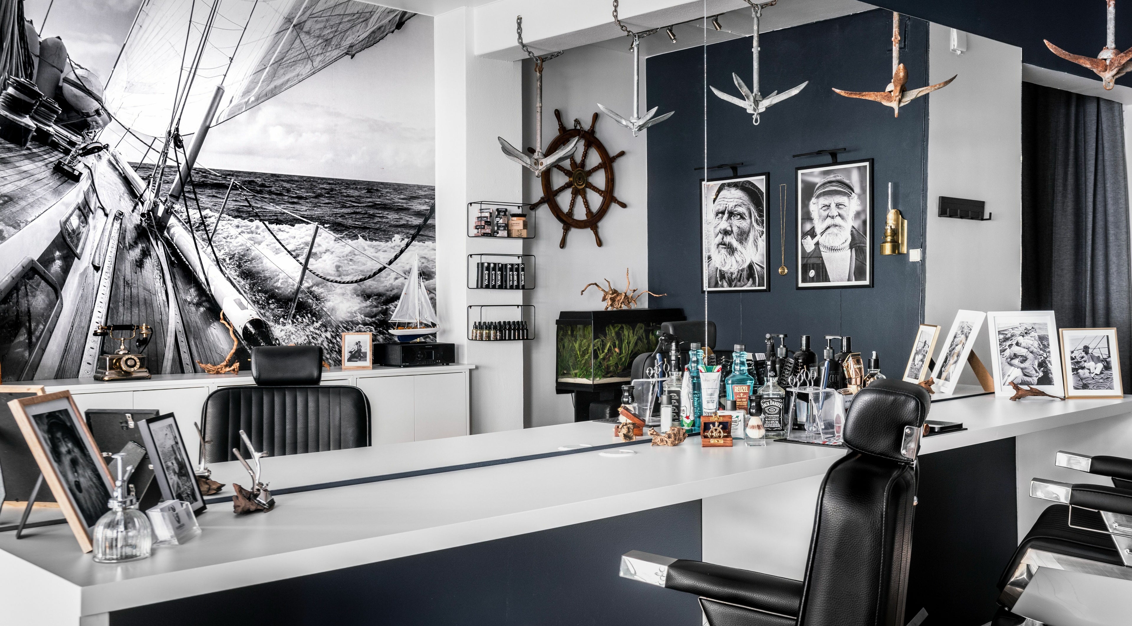Interior of Old Sailor Barbershop in Oslo, Oslo, NO, featuring nautical decor and barber chairs.