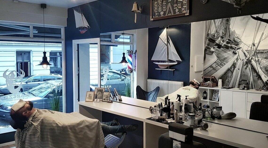 Interior of Old Sailor Barbershop in Oslo, Oslo, NO showcasing nautical decor and a customer reclining.