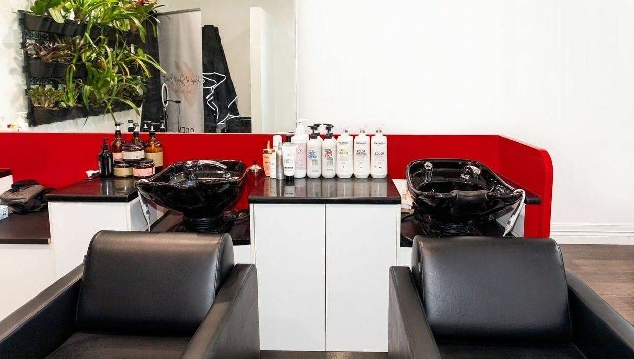 Modern wash stations at Cosimo Hair Studio | Broadbeach, Broadbeach, Queensland, AU featuring sleek black chairs.