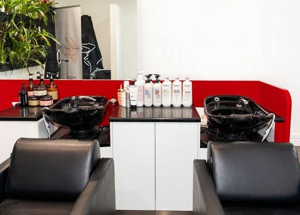 Modern wash stations at Cosimo Hair Studio | Broadbeach, Broadbeach, Queensland, AU featuring sleek black chairs.