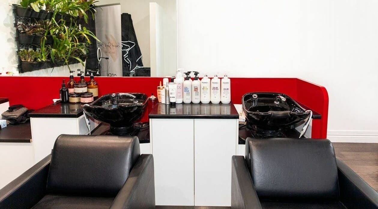 Modern wash stations at Cosimo Hair Studio | Broadbeach, Broadbeach, Queensland, AU featuring sleek black chairs.