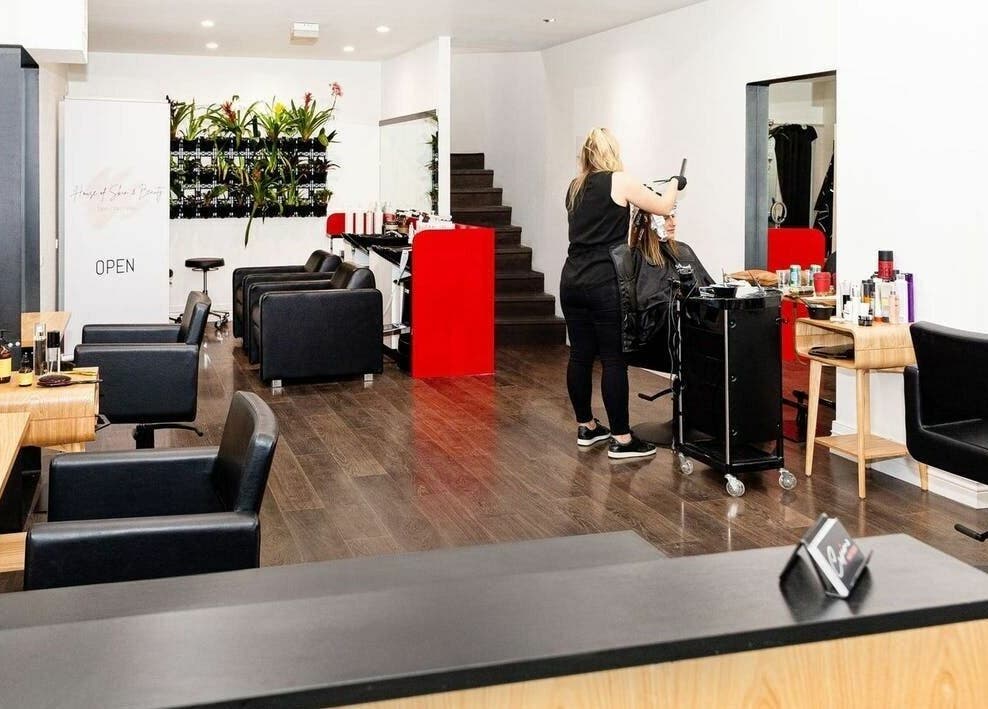 Interior of Cosimo Hair Studio | Broadbeach with stylist at work, located in Broadbeach, Queensland, AU.