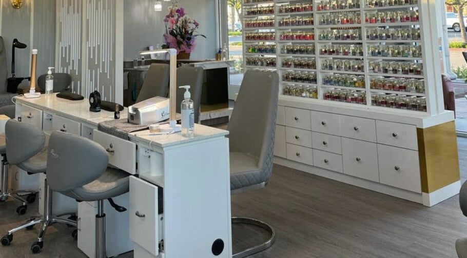 Modern manicure station at Bonjour Nail Bar, Rancho Cucamonga, California, US, showcasing nail polish collection.