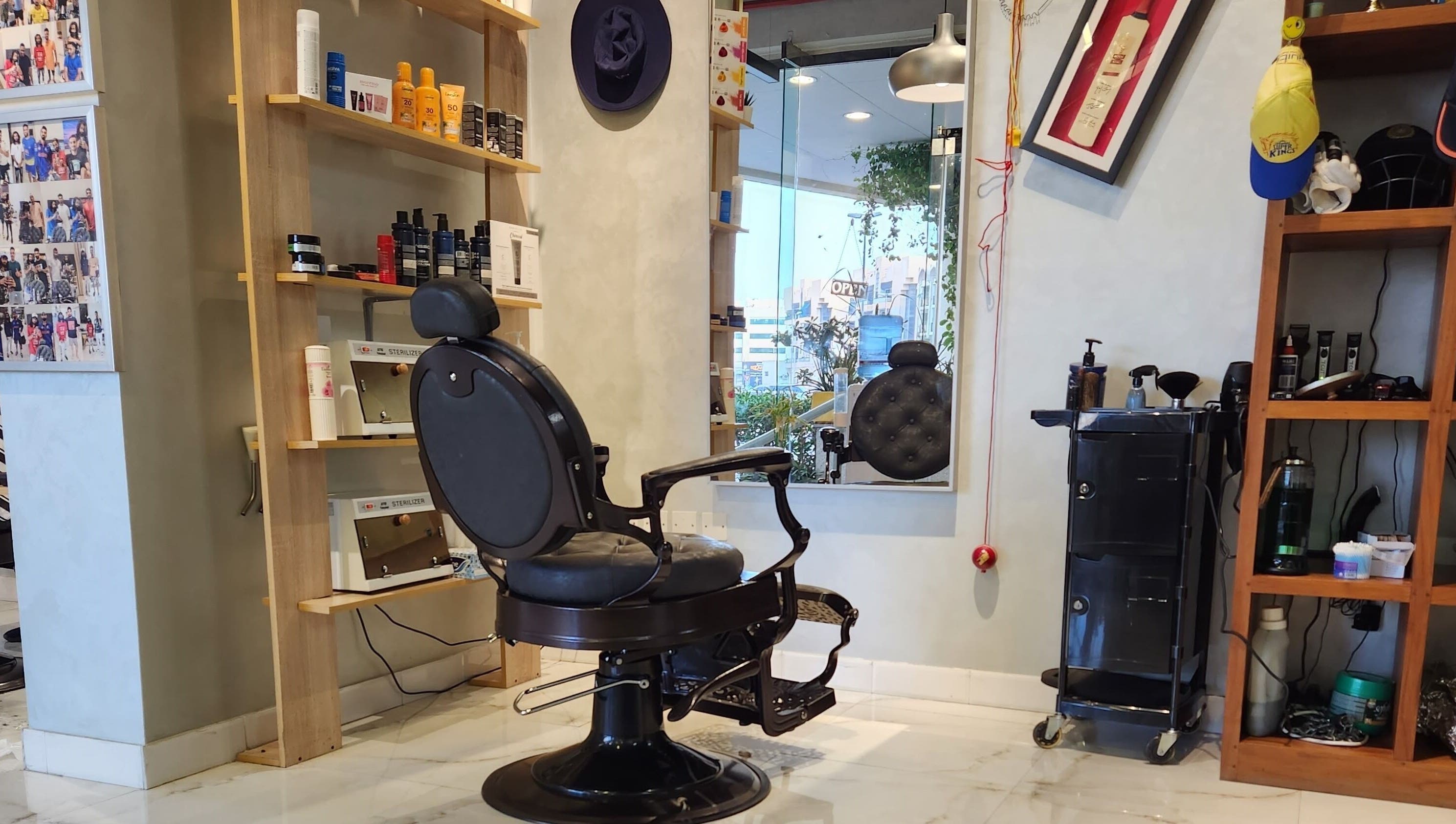Chic interior of Blade & Beard Men Salon, Dubai, AE, showcasing barber chair and grooming products.