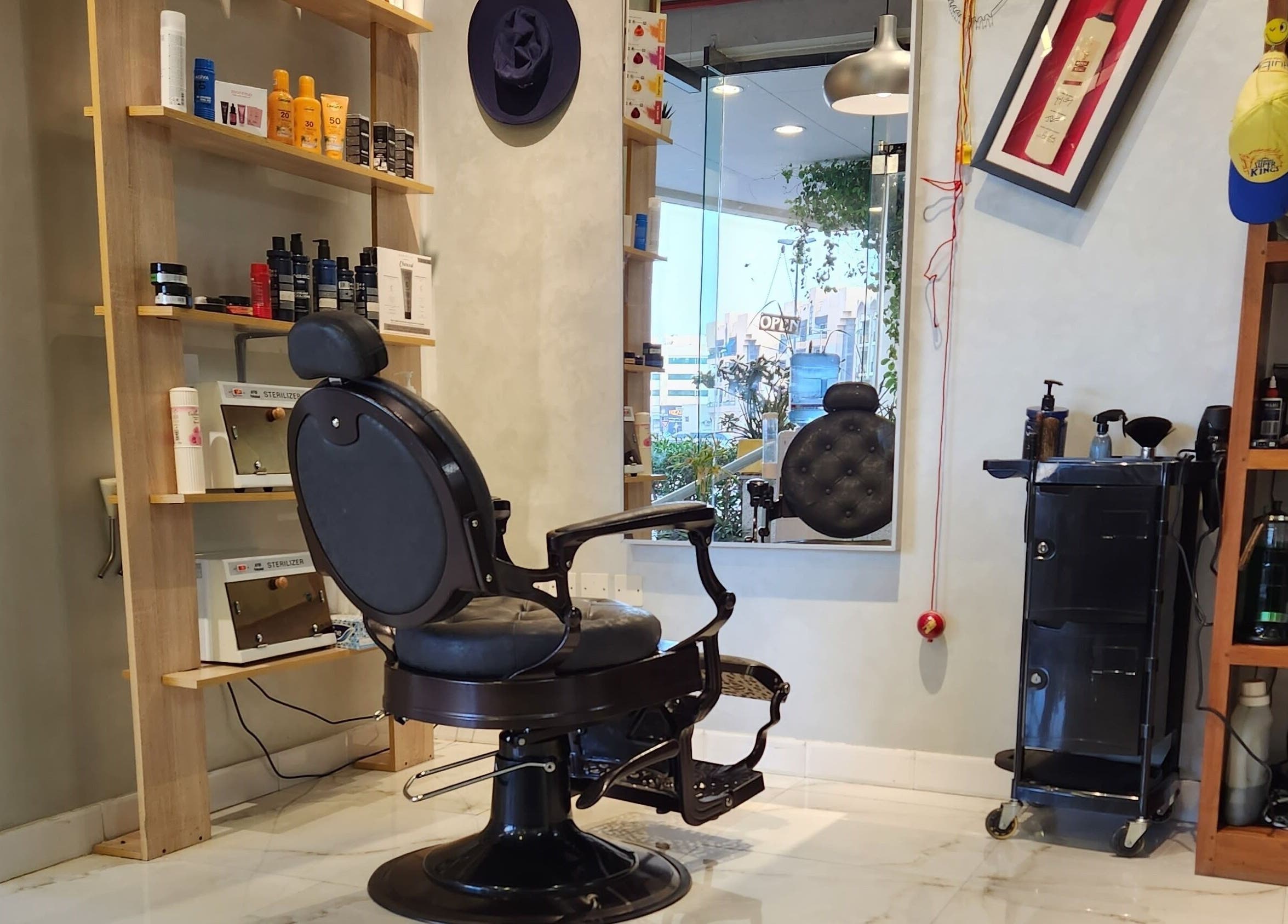 Chic interior of Blade & Beard Men Salon, Dubai, AE, showcasing barber chair and grooming products.