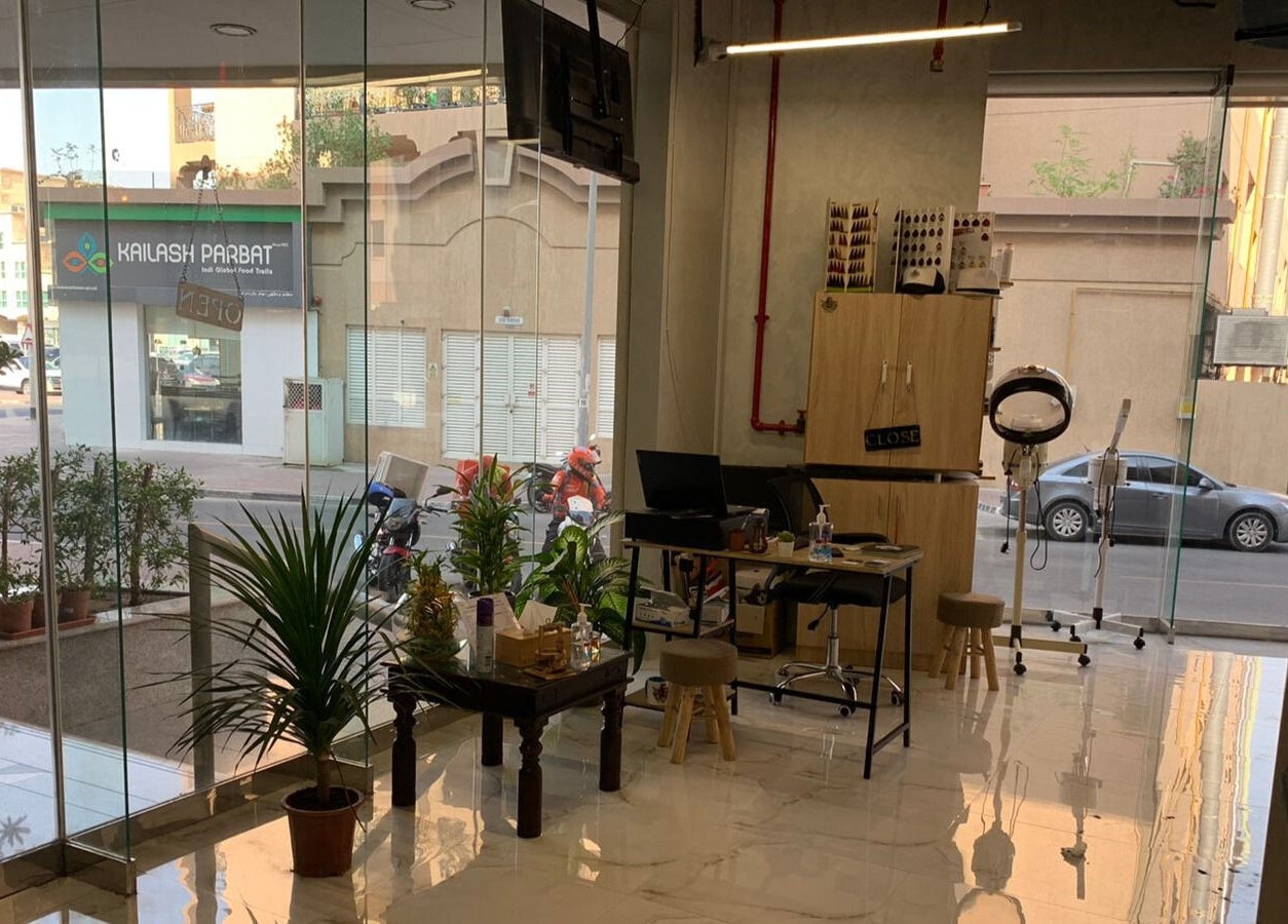 Inviting interior of Blade & Beard Men Salon in Dubai, AE featuring modern decor and lush greenery.