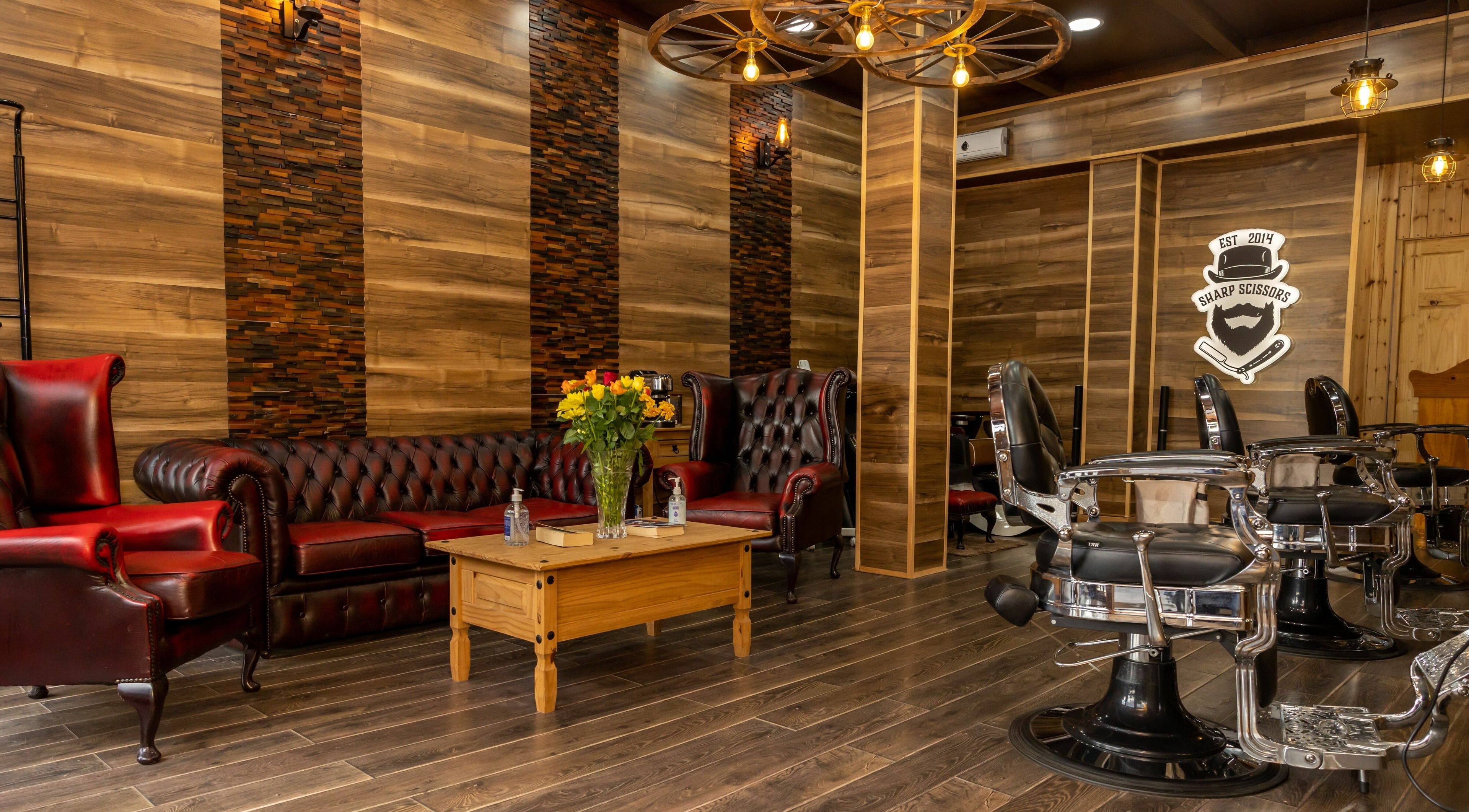 Elegant interior of Sharp Scissors in Glasgow, Scotland, GB with leather chairs and wood decor.