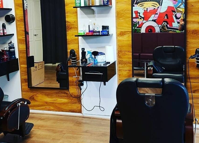 Modern salon interior at Sharp Scissors in Glasgow, Scotland, GB. Stylish chairs and hair products displayed.