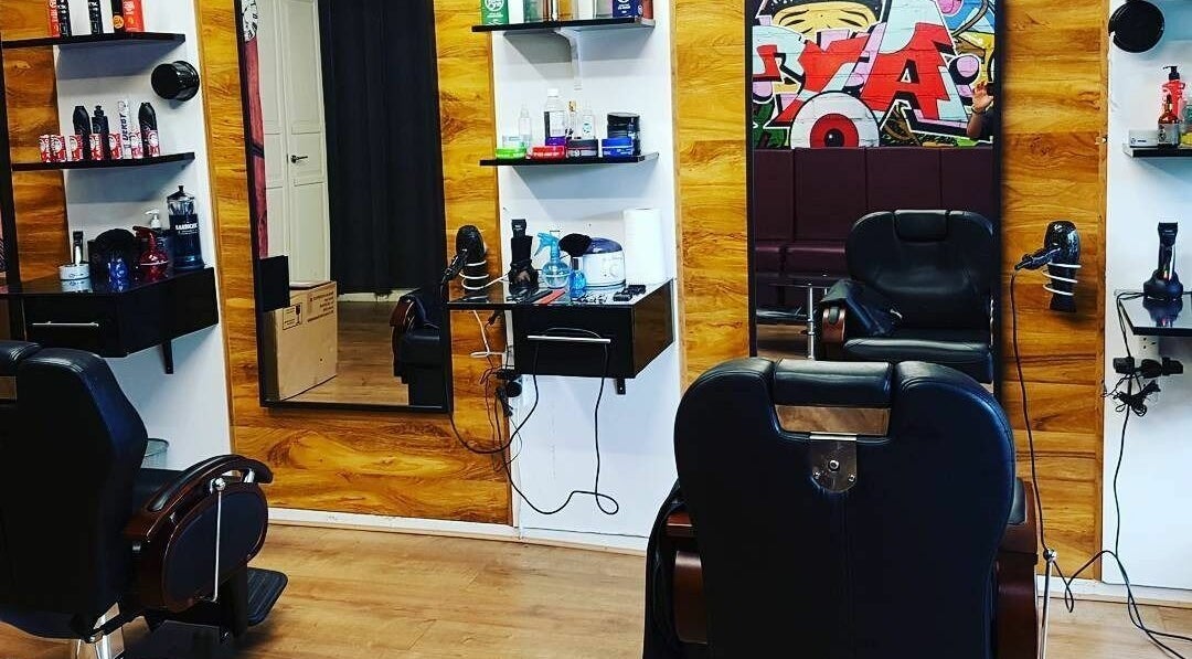 Modern salon interior at Sharp Scissors in Glasgow, Scotland, GB. Stylish chairs and hair products displayed.