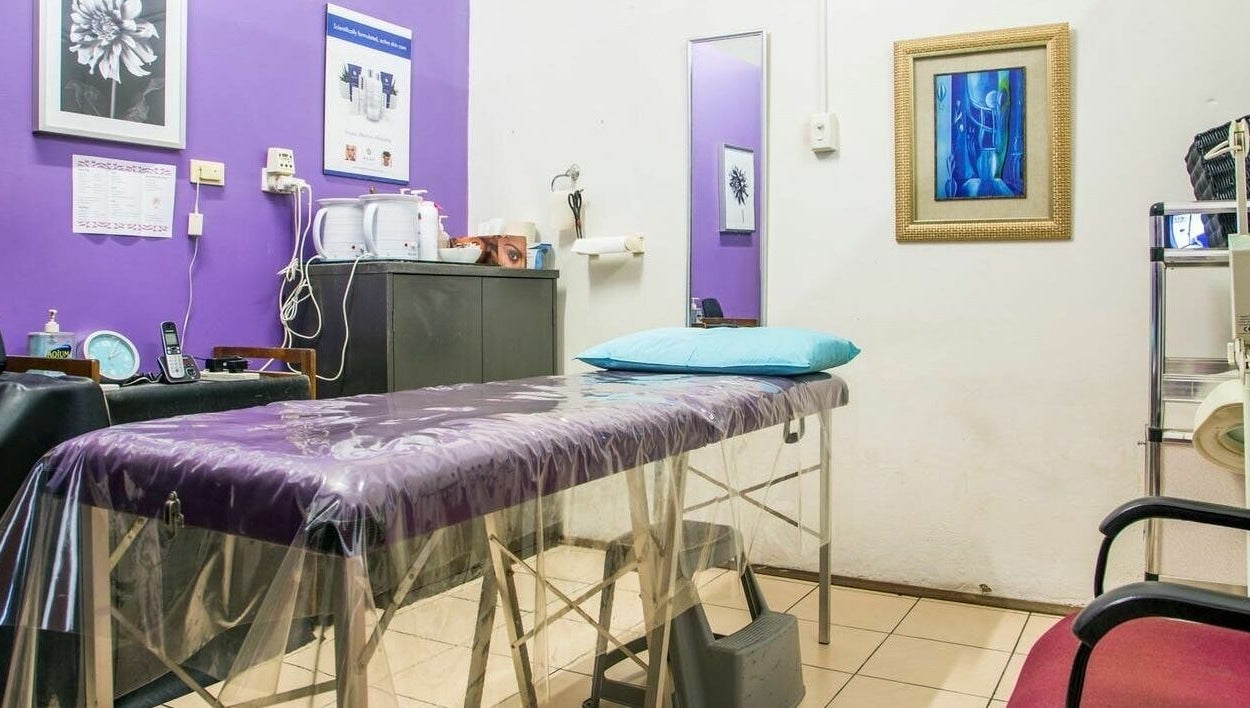 Tranquil waxing room at Just Wax It, Seaton, South Australia with purple walls and a treatment bed.