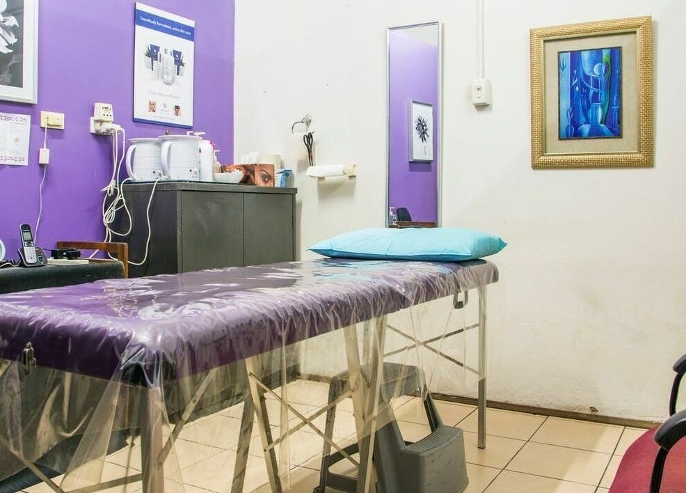 Tranquil waxing room at Just Wax It, Seaton, South Australia with purple walls and a treatment bed.